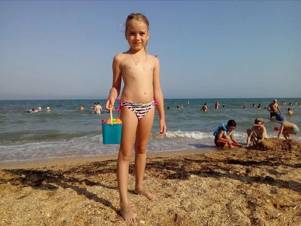 kid on beach with pail 960x720