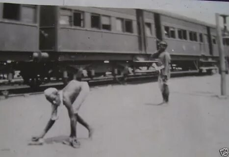 File:A crippled man near a train in India in the 1920s.JPG -