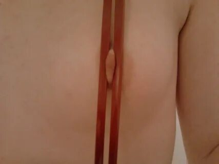 Nipple clamped with a chopstick - breast torture