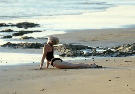 Miley Cyrus yoga in black bikini on beach in Hawaii 1/24/13 