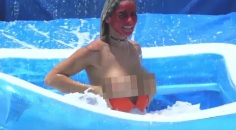 Boobs burst out of bikinis as models fly down water slide on
