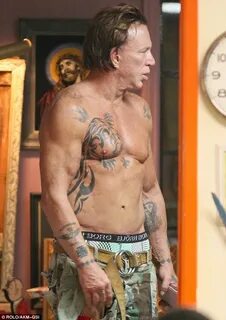 Mickey Rourke whips off his shirt to get ANOTHER tattoo Dail