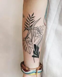 Tropical black leaves tattoo on the right forearm Pattern ta