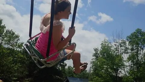 little girl riding swing amusement park: стоковое видео (без