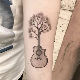 Surrealist guitar tree tattoo on the left inner