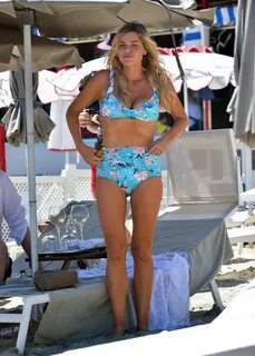 Sophie Monk In a blue bikini while filming a tv show on the 
