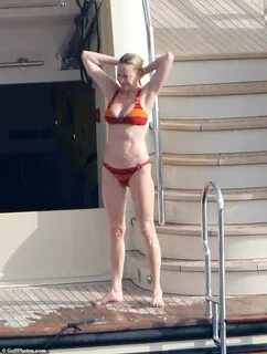 Melanie Griffith, 61, sizzles in an orange striped bikini ab