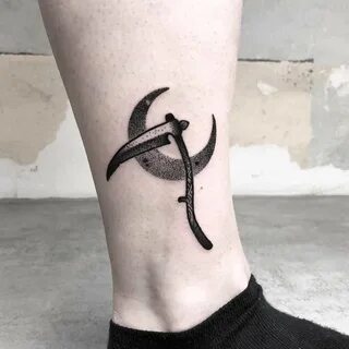 Blackwork scythe and crescent moon tattoo on the right ankle