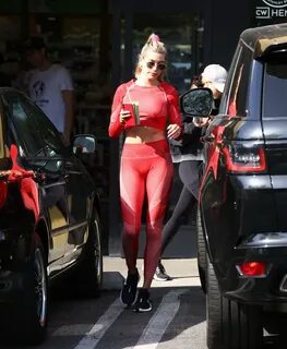 Hailey Baldwin in a red crop top and tights leaving the gym 