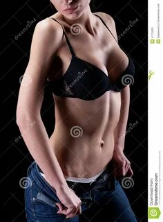 Young woman takes off her clothes sensually.