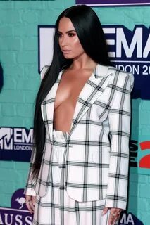 Demi Lovato braless in a wide open plaid pantsuit at 24th MT