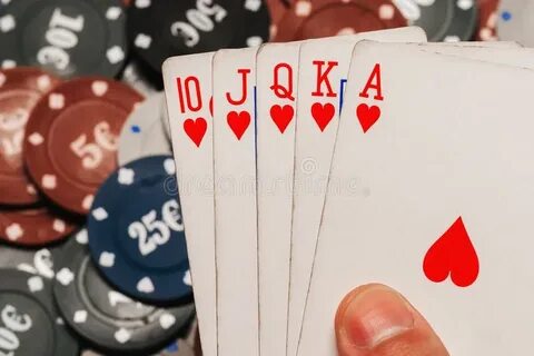 Royal Flush in Poker in the Hands of the Player on the Backg