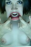 Cute brunette teen with braces stretches her mouth wide open