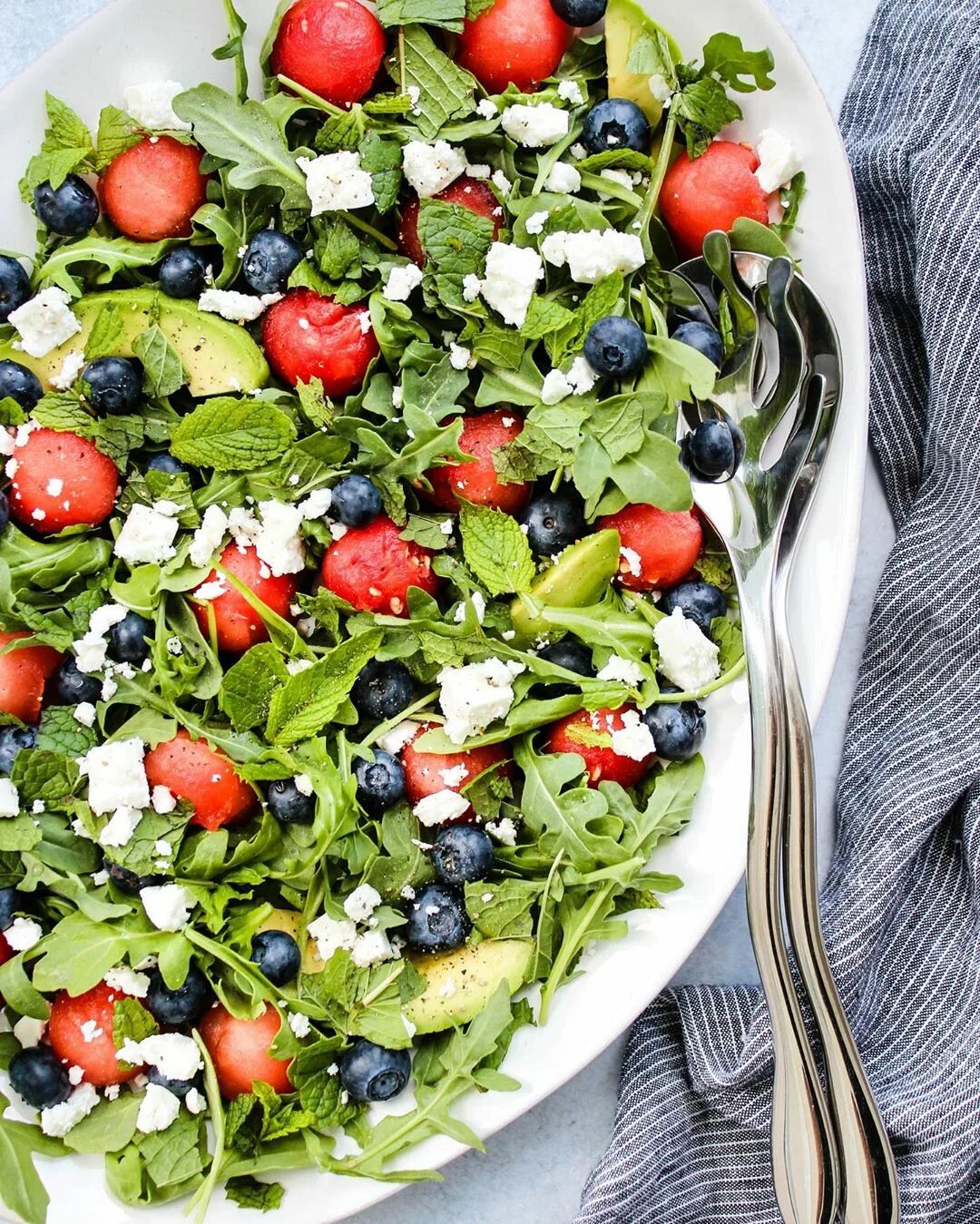 This watermelon salad made with feta, arugula, blueberries, and mint SERIOU...