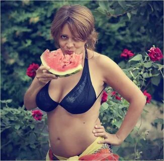 Woman smashing watermelon with boobs