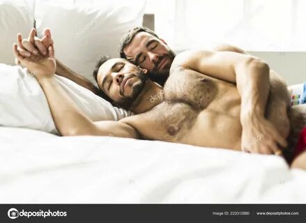 A Handsome gay men couple on bed together Stock Photo by © L