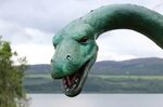 Loch Ness Monster Statue with Loch Ness in the Background St
