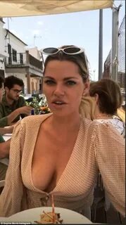 Sophie Monk goes braless in a plunging pink top during lunch