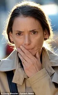 Winona Ryder, 42, dresses down in beige coat and little make