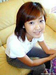 Asian teen strips on sofa and poses