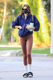 kaia gerber showcases her slender frame in brown leggings an