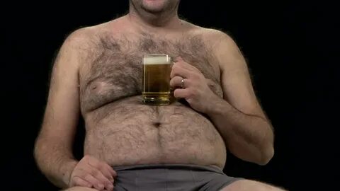 Hairy overweight man easily emptying beer glass.. - Royalty 