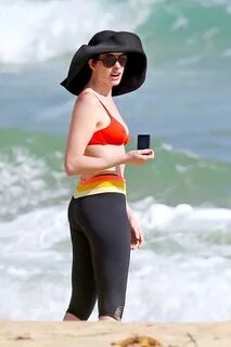 Anne Hathaway showing pokies in wet bikini tops on a Hawaiia