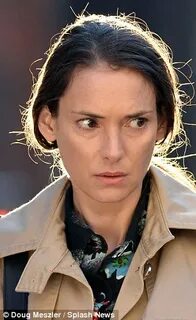 Winona Ryder, 42, dresses down in beige coat and little make