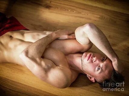 Totally naked muscular young man laying on floor Photograph 