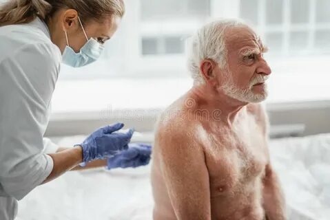 Shirtless Old Man Receiving Injection in Back while Sitting 