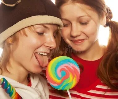 Two funny girls with lolly-pop. close up.