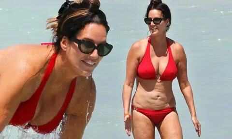 Patti Stanger pours out of crimson bikini as she steps into 