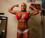 Blonde fitness muscle woman pumping Iron Goddess