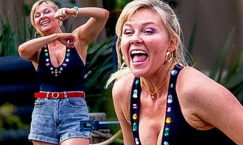 Kirsten Dunst dances in cleavage- bearing bedazzled swimsuit