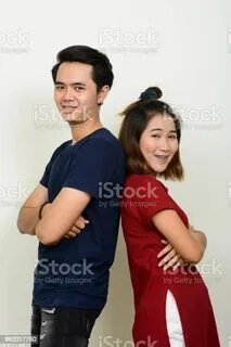 Young Asian Man And Young Asian Woman Together Against White