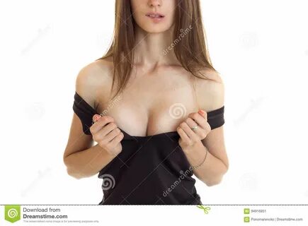 Photo about Woman bite a lips and take off a shirt to shows a big silicon b...