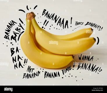 raw fresh yellow bananas on wooden background with symbol and lettering Sto...