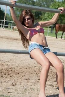 Young Girl in the Farm Farm with Top Bikini and Shorts Stock