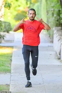 Shia LaBeouf works up a sweat on his daily run in red T-shir