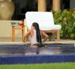 Kim Kardashian caught in wet see-through top and bikini bott