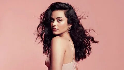 Camila Mendes Is Wearing Peach Dress Standing In Peach Wall 