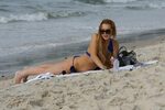 Lindsay Lohan bursting out of her soppy blue bikini at a bea