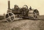 Ottomeyer plow engine pulling a cable plow through field. Ge