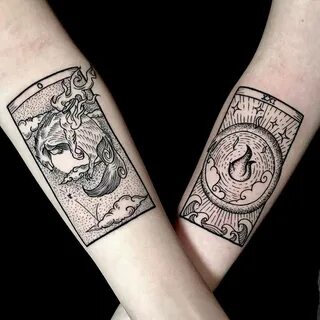 Matching occult card tattoos.
