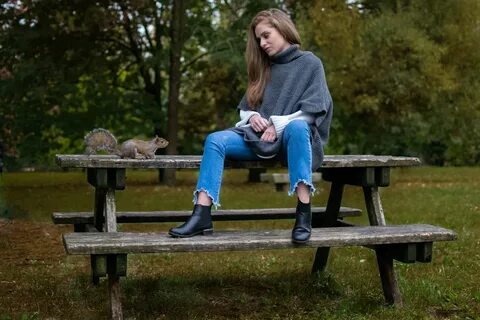woman in blue denim pants sitting on picnic table outdoor ph