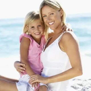 Mother And Daughter Sitting Together On Beach - License, dow