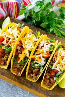 Crispy ground beef tacos with an assortment of toppings like