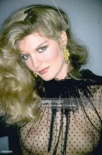 Rene Russo, in Christian Dior's black point d'esprit blouse 