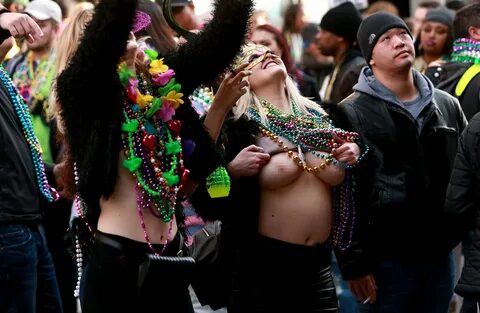 New Orleans Mardi Gras festival sees women flash their boobs as thousands turn o