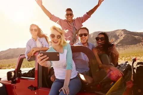 Friends On Road Trip In Convertible Car Taking Selfie Лучший
